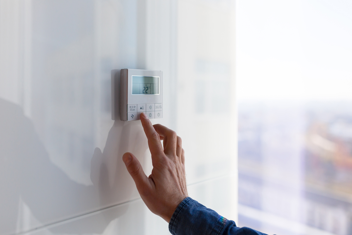 The air conditioning and heating control panel for the apartment and office is located on a white wall The air conditioning and heating control panel for the apartment and office is located on a white wall